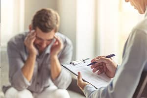 a therapist discusses a trauma informed care program with a client