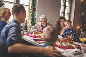 A family unplugging from work to enjoy a happy and relaxed Christmas dinner together.