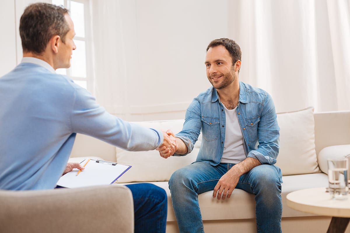 Man and therapist developing a wellness recovery action plan