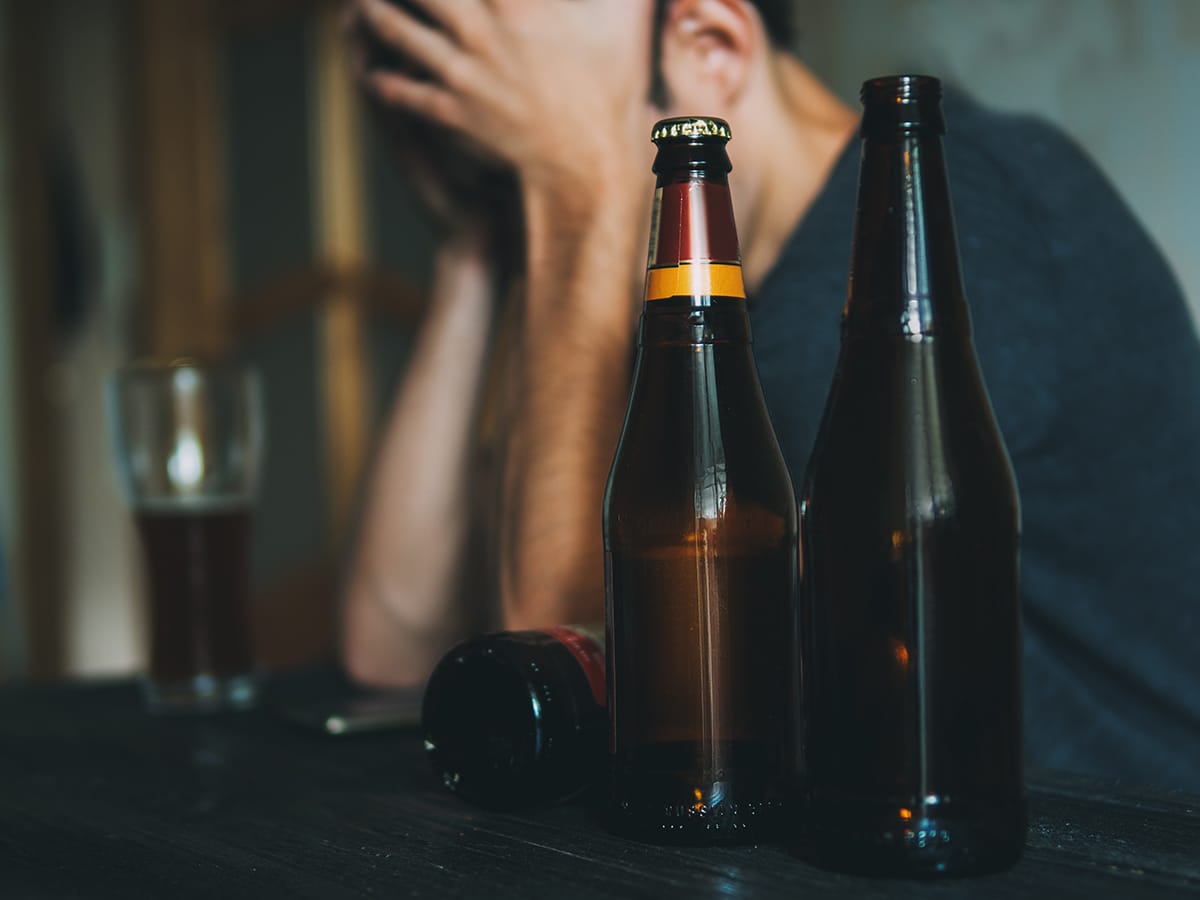 Man dealing with symptoms of alcohol use disorder