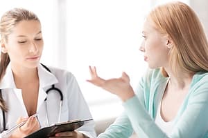Woman speaks to a doctor at her dual diagnosis treatment center