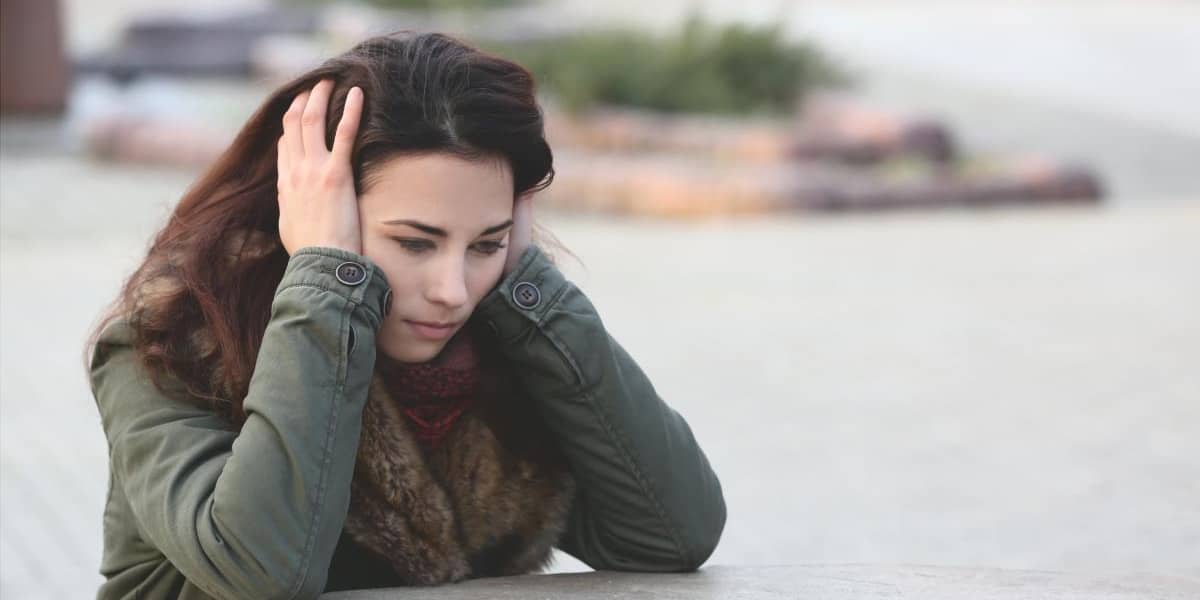 woman sitting and struggling with anxiety triggers