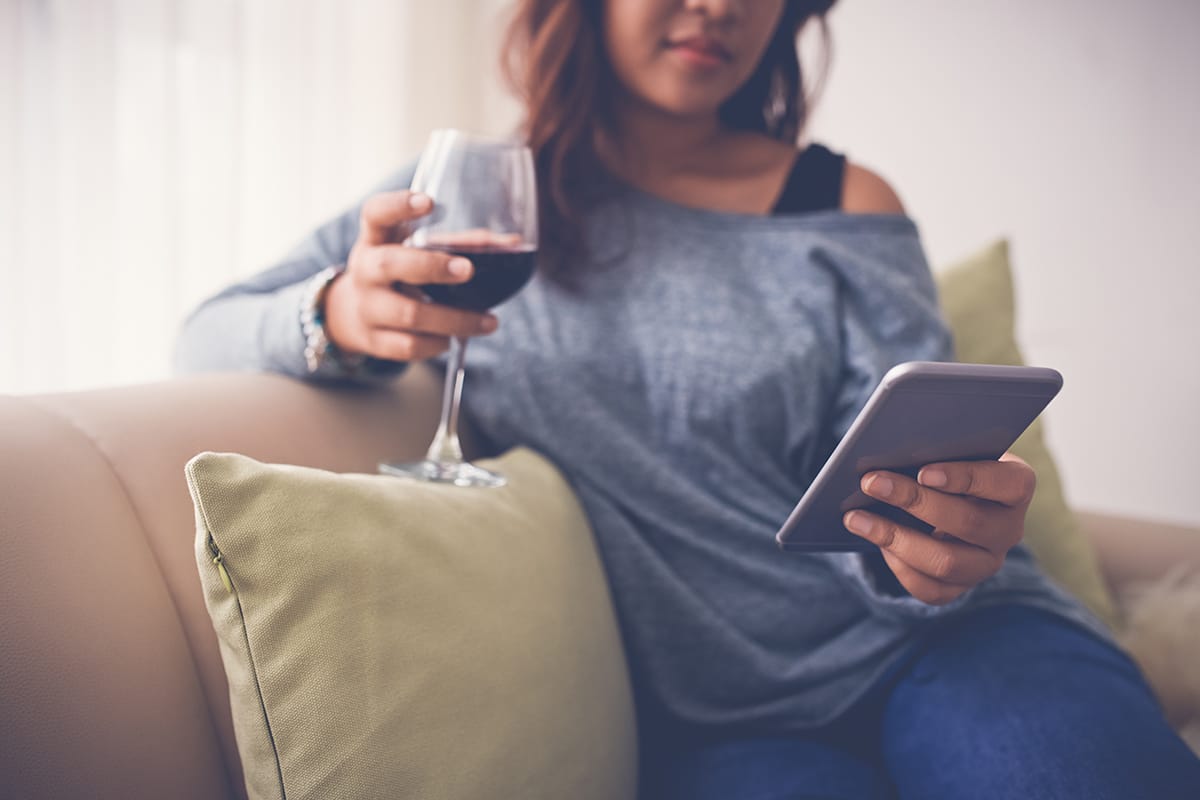 a woman reading unaware of the connections between drinking and social media