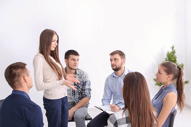 group in a recovery program discussing outpatient treatment and your job