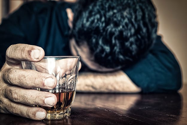 man struggling with alcohol addiction