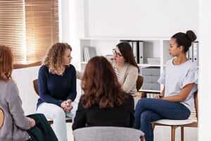 Women bond during group therapy for women