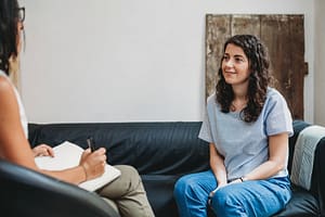 Woman talks to therapist in alcohol treatment center