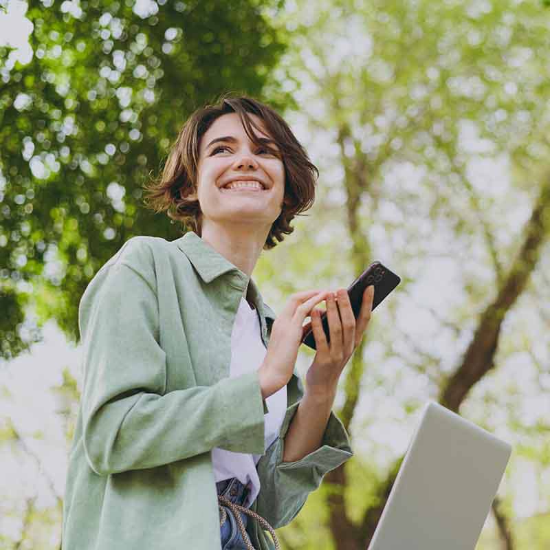 Woman smiles as she texts friend about insurance verification