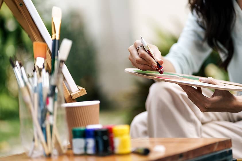 Woman paints during art therapy