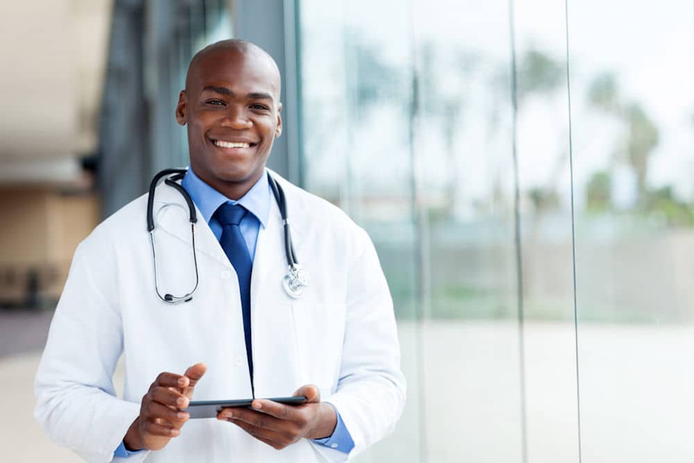 smiling doctor with tablet