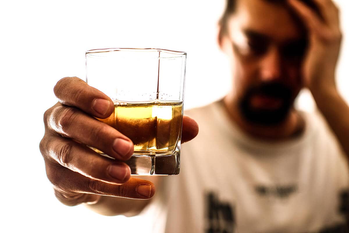 man resisting his drink on national alcohol screening day