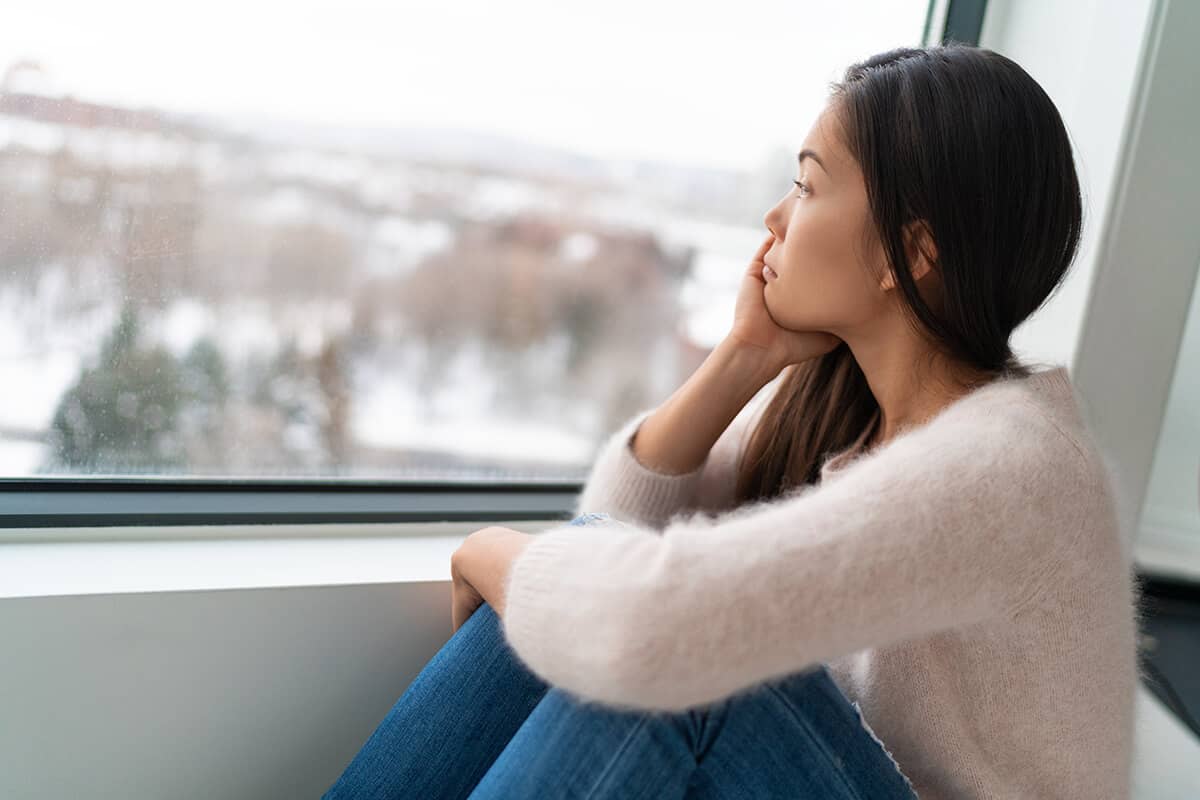 woman with a substance induced mood disorder looking out window