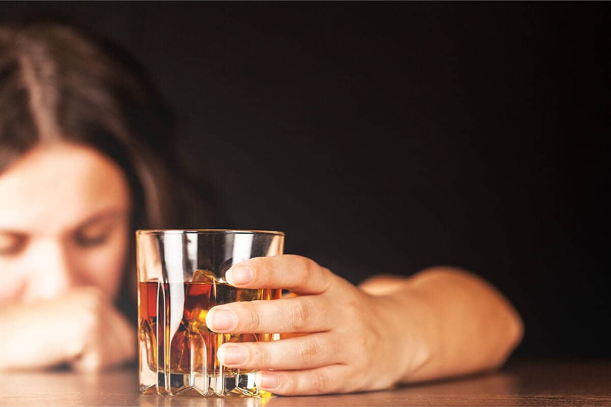woman suffering from risks of alcohol abuse