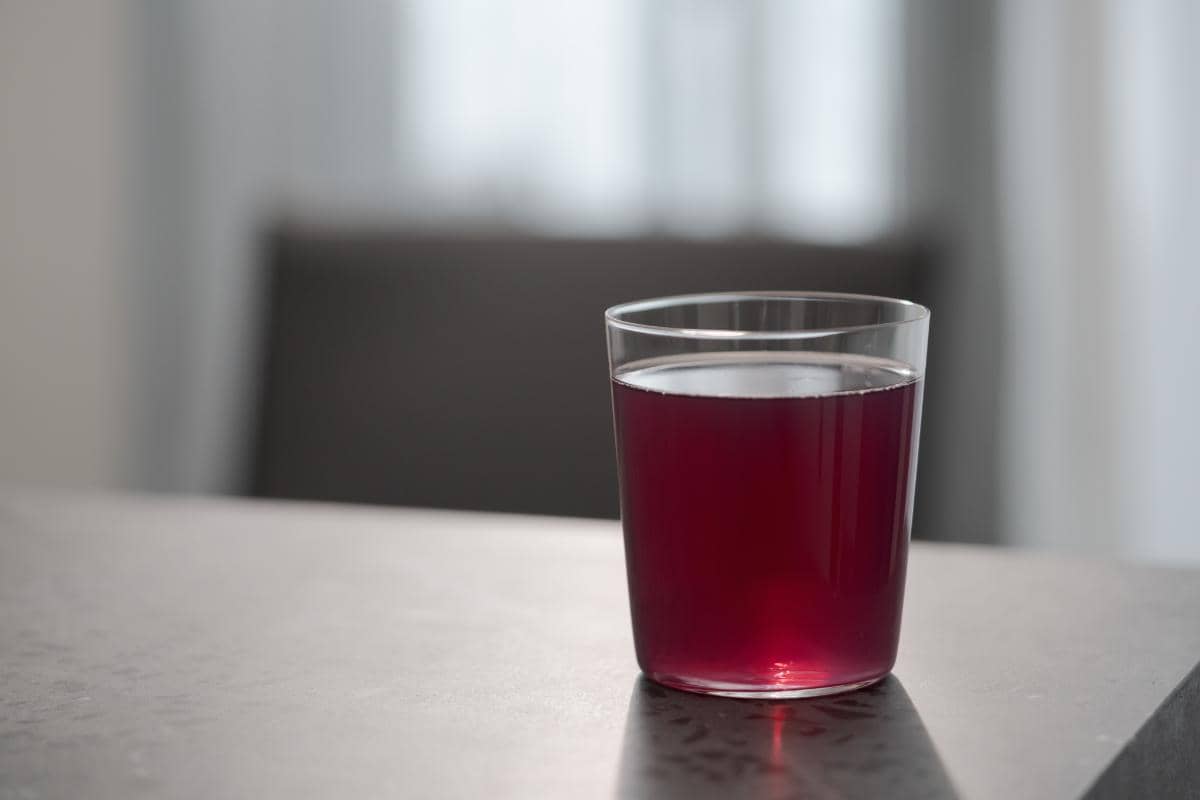 A glass of purple drank that hints at the effects of purple drank