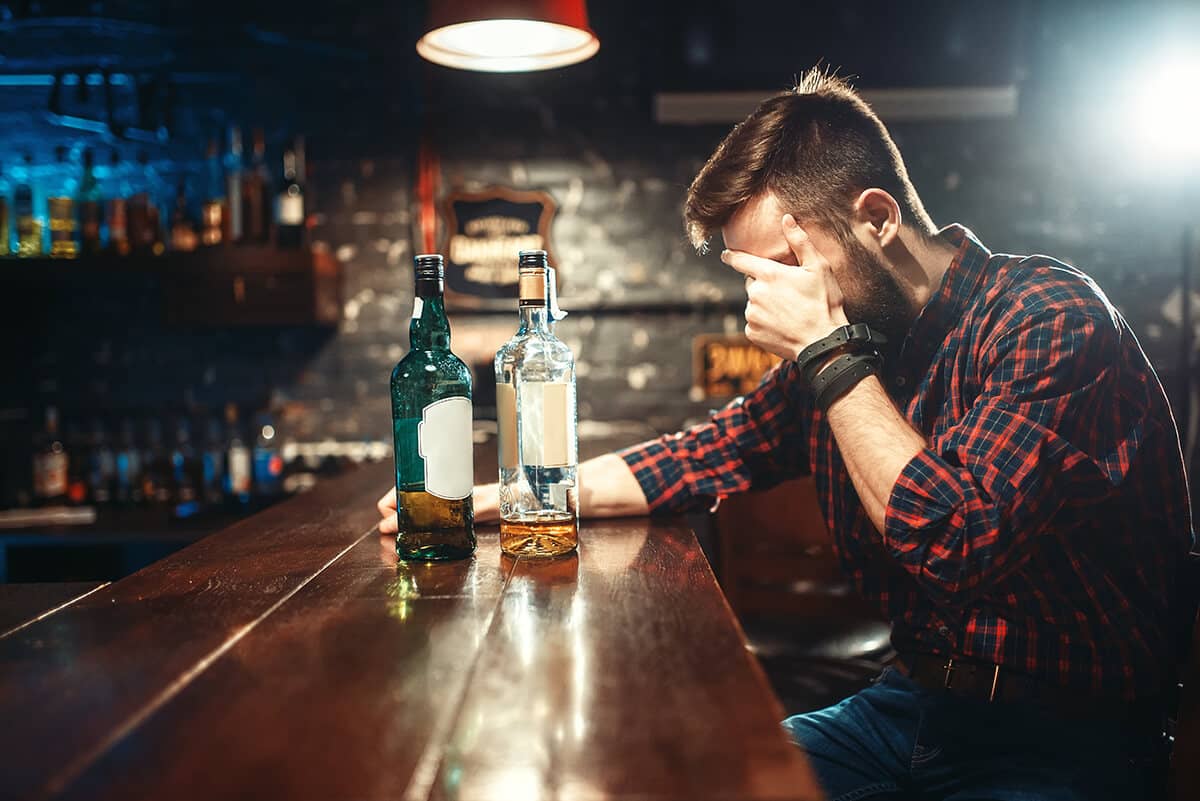 man in a bar struggling with beating alcoholism