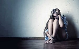 young woman experiencing withdrawal wonders about drug addiction definition