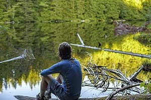 man sitting by the lake at a drug rehab center near Bellingham, Washington