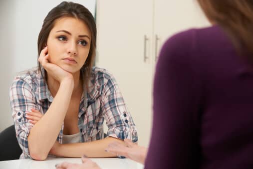 teenage girl with depression visits counsellor to learn how to quit opiates for the long term