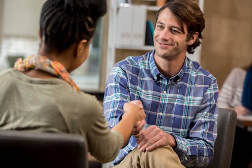 patient talks to counselor during dialectical behavioral therapy in mens drug rehab program