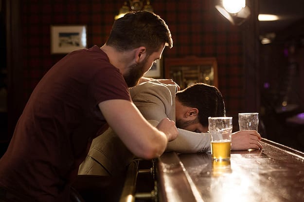 man wonders how to help an alcoholic while he tries comforting his friend