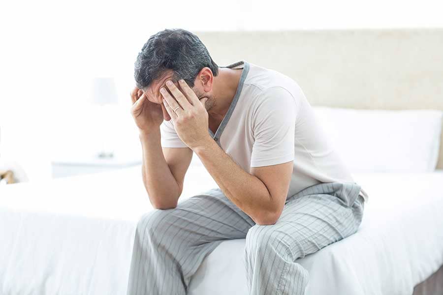 man with headache wonders what is psychological dependence