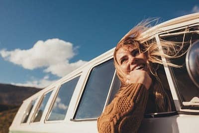 woman traveling in a van looking out the window
