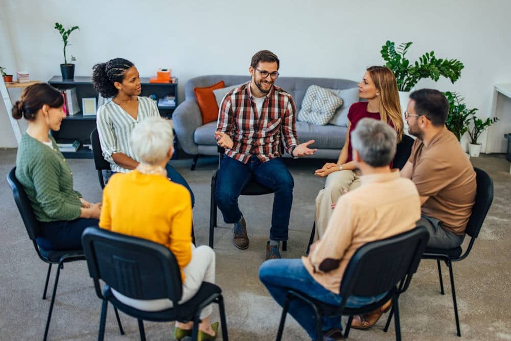 diverse group sitting in chairs for therapy