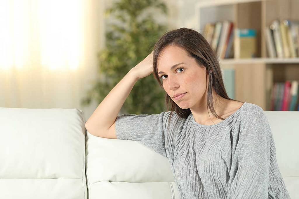 woman on couch learning about Mental Illness Awareness Week