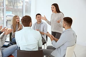 woman talking in group therapy at a prescription drug addiction treatment center