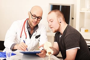 Young man and doctor discussing medical alcohol detox