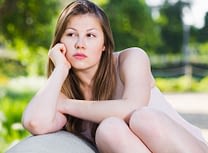 Sad young woman want to learn how to stop addiction at Serenity House Detox.