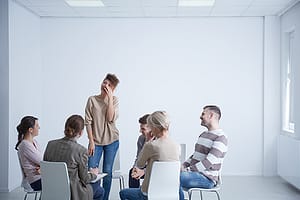 person standing and sharing their story at a group mood disorder treatment center in florida