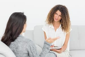 Therapist talking to woman about a holistic approach to detox