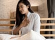 woman holding hand to chest suffering side effects of oxycodone