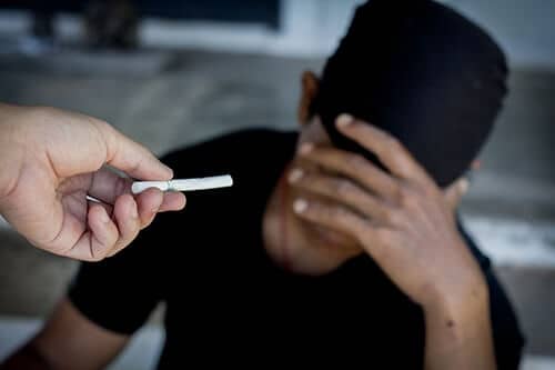 man getting handed a cigarette has relapse triggers