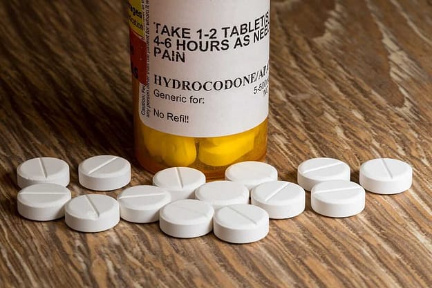 is hydrocodone an opioid prescription pills and bottle on a table