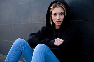 young woman in black hoodie has heroin side effects
