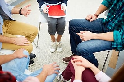 five people at addiction recovery support groups