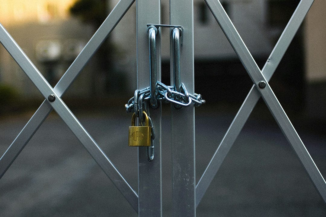 A chain and padlock securing a fence gate, symbolizing data protection and security standards like HITRUST certification within healthcare