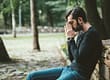 Stressed out young man sitting in a park