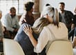 a woman hugging her daughter as they discuss examples of recovery group topics in a a group setting