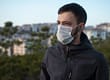 man outside wearing mask knowing difference between epidemic vs pandemic