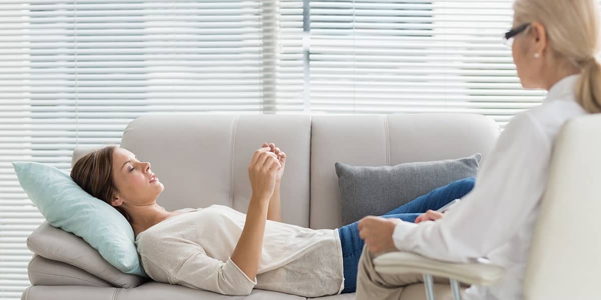 Woman on couch receives therapy for her co-occurring disorders
