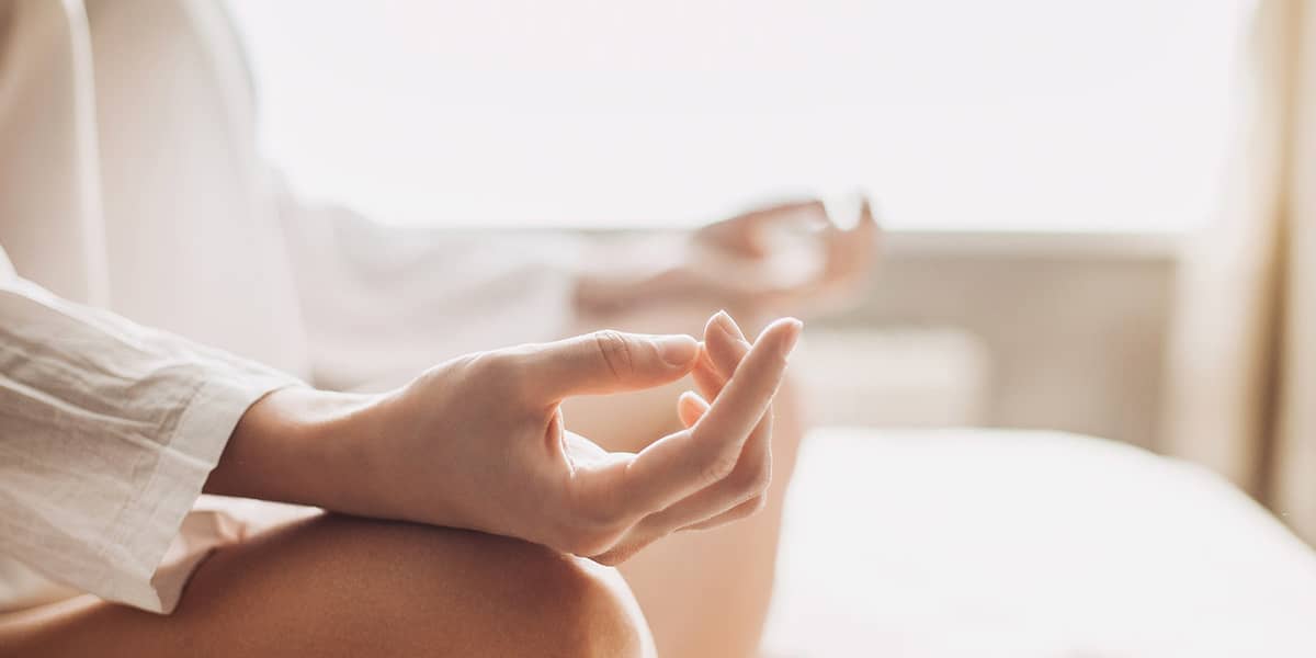 a woman meditating after asking can mindfulness meditation work for addiction
