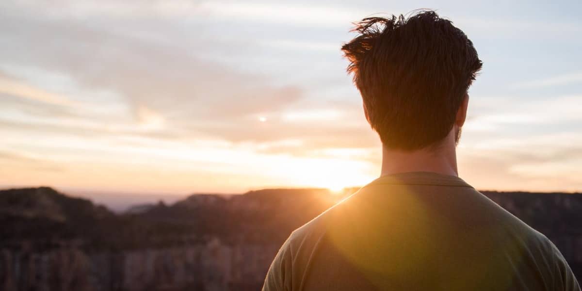 man looking at sunset celebrating a sober new year