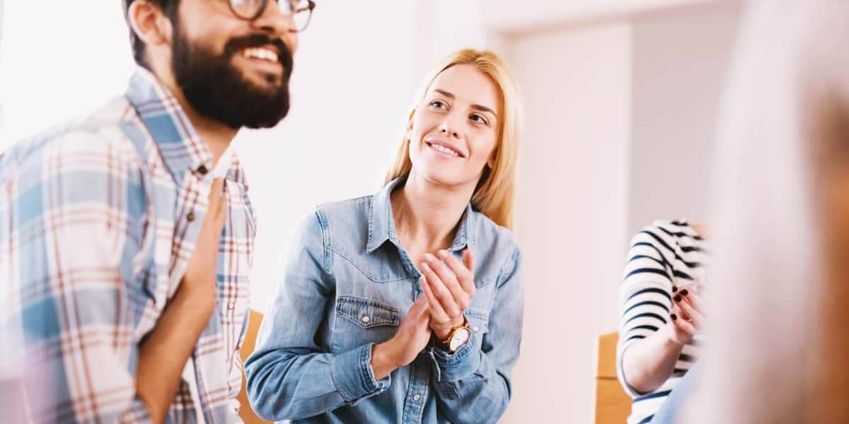 man smiling in group at drug abuse treatment programs