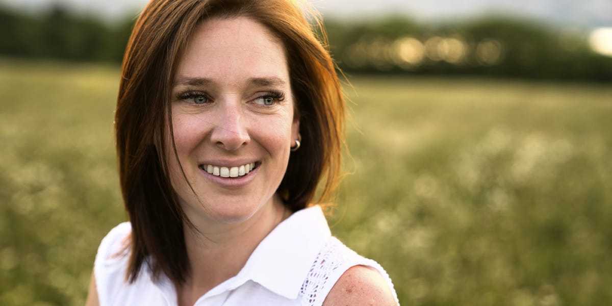 woman outside smiling having quit drinking