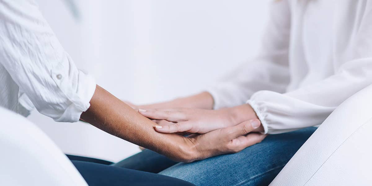 people holding hands practicing mindfulness training