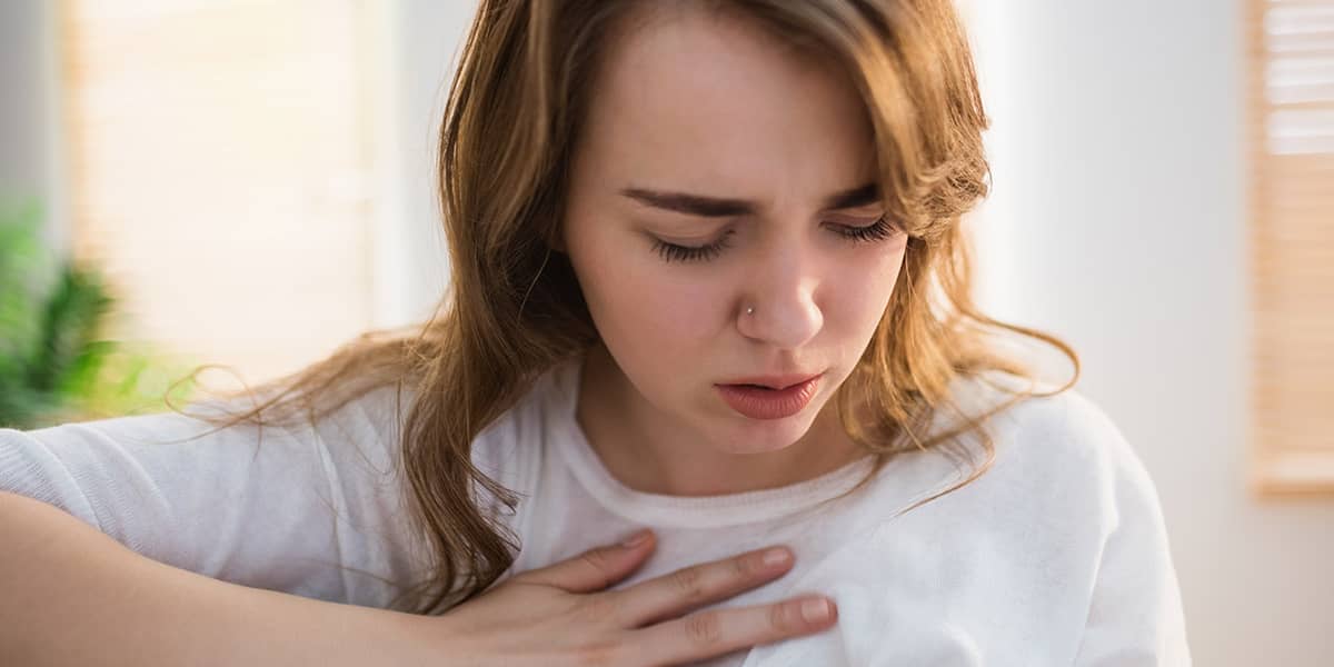 a woman holding her chest wondering what does narcan do