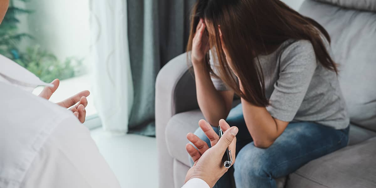 substance abuse counselor talking to crying patient